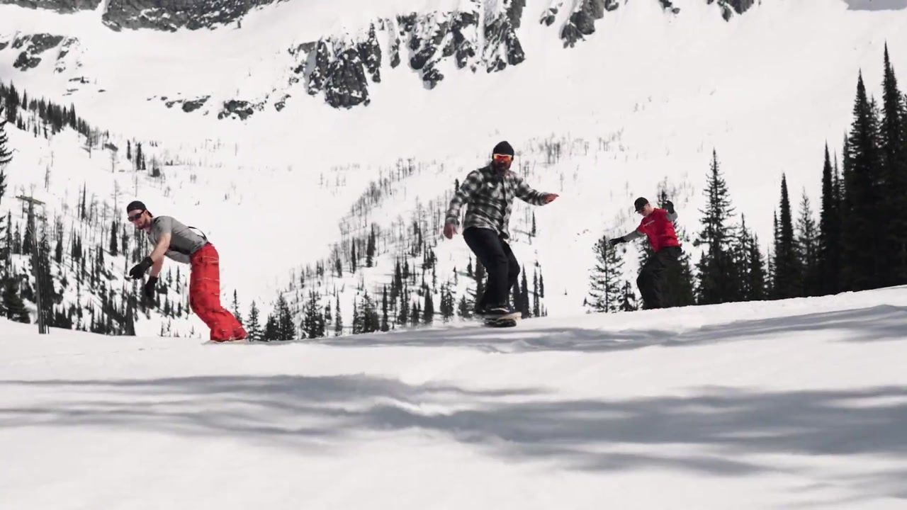 SlopeDeck riders carving across a snowy mountainside